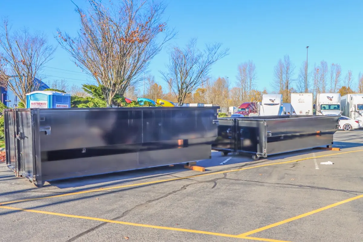 Professional dumpster rental service with roll-off container on residential driveway in North Decatur